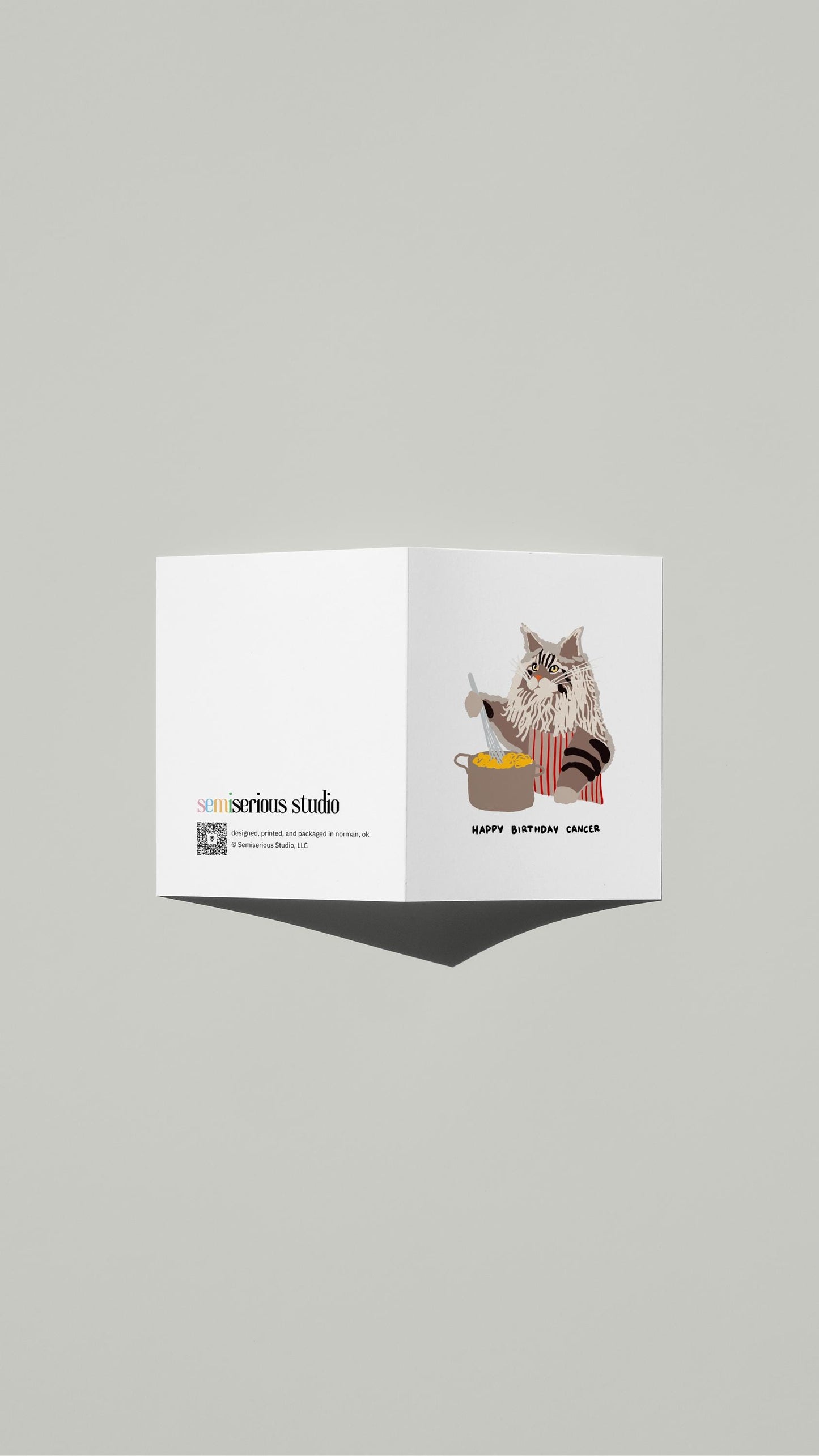 Cancer Maine Coon Pasta Birthday card standing open, showing the front artwork and the Semiserious Studio logo on the back
