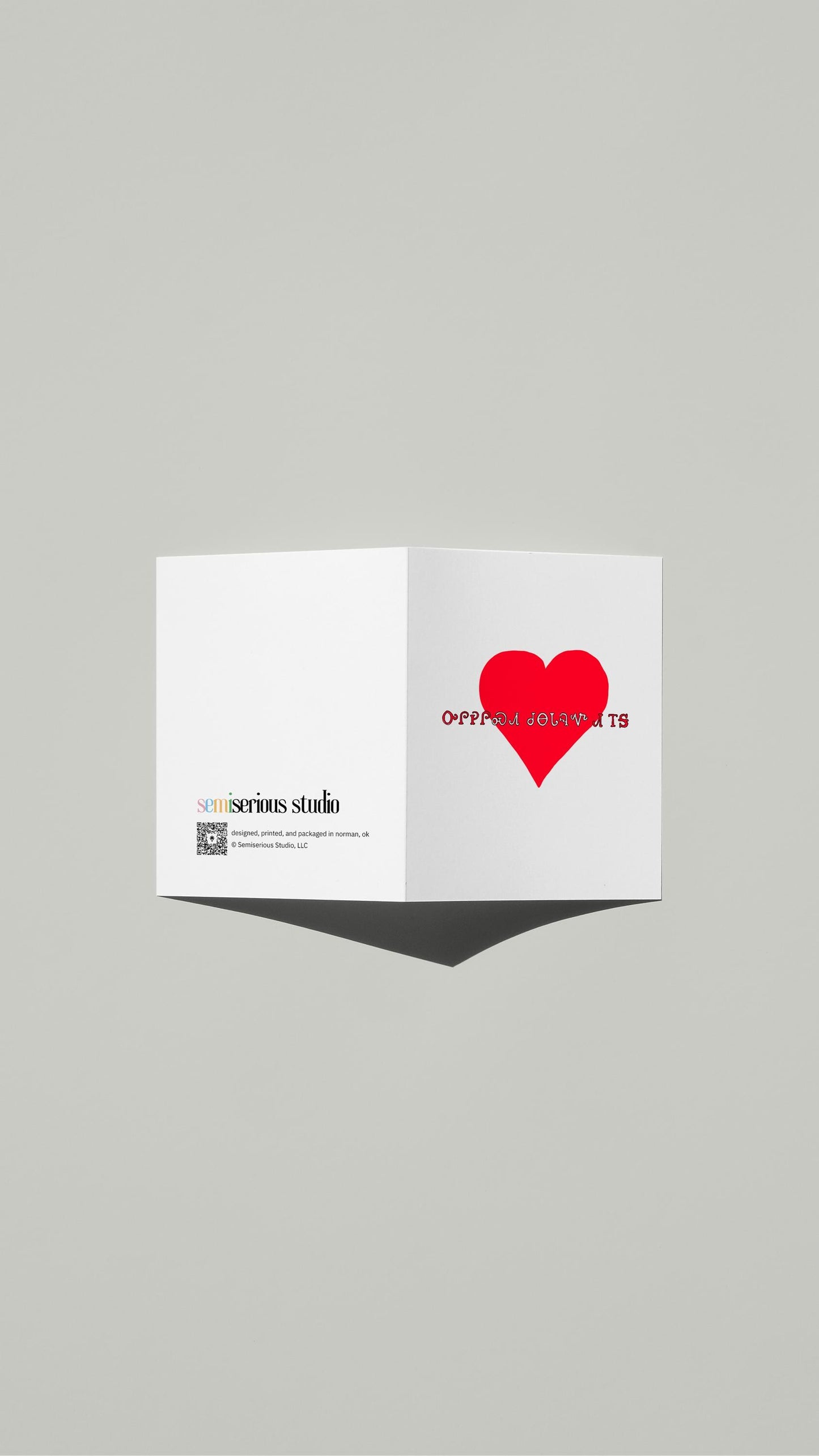 Cherokee Syllabary Valentine card standing open, showing the front artwork and the Semiserious Studio logo on the back