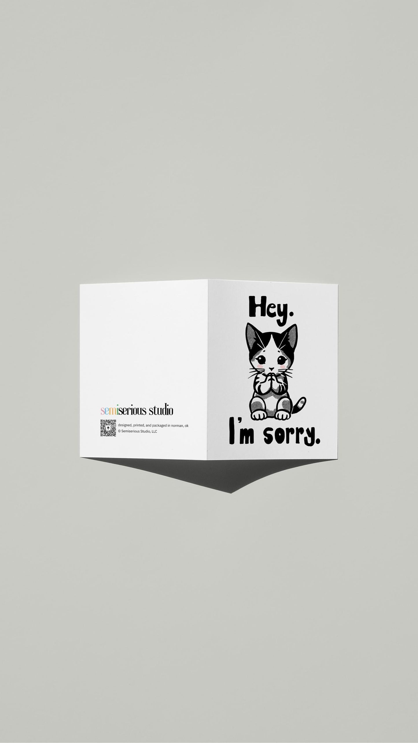 Hey I'm Sorry Kitten Apology card standing open, showing the front artwork and the Semiserious Studio logo on the back
