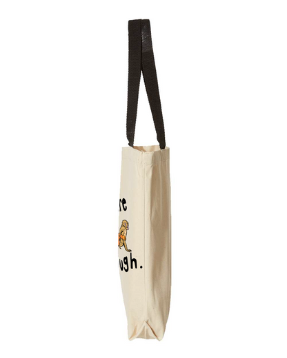 Side view of the natural canvas tote bag with black handles