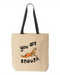 Natural canvas tote bag with black handles, printed with a small monkey holding an orange stuffed animal and the words you are enough