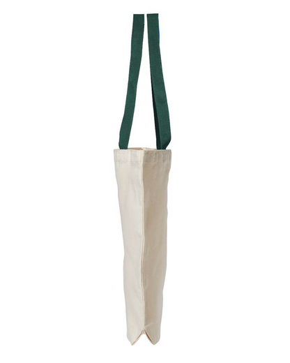 Side view of the natural canvas tote bag with green handles, showing the 3 inch gusset