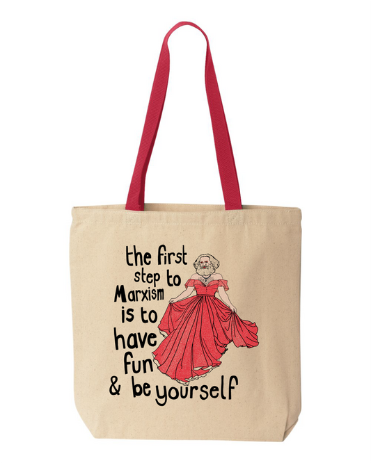 Natural canvas tote bag with red handles, printed with Karl Marx in a red ball gown and the words the first step to Marxism is to have fun & be yourself