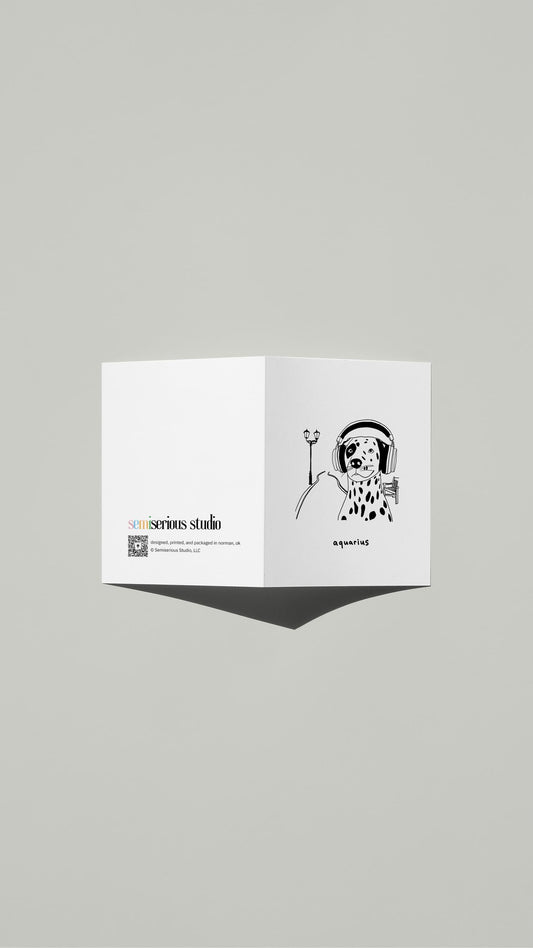 Aquarius Dog Birthday card standing open, showing the front artwork and the Semiserious Studio logo on the back