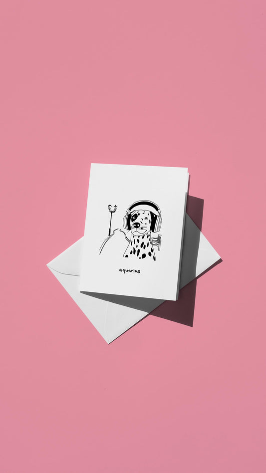 Hand-drawn illustration of a Dalmation wearing headphones with the message "aquarius"