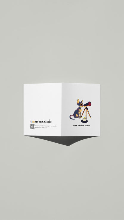 Aquarius Sphynx Cat Birthday card standing open, showing the front artwork and the Semiserious Studio logo on the back