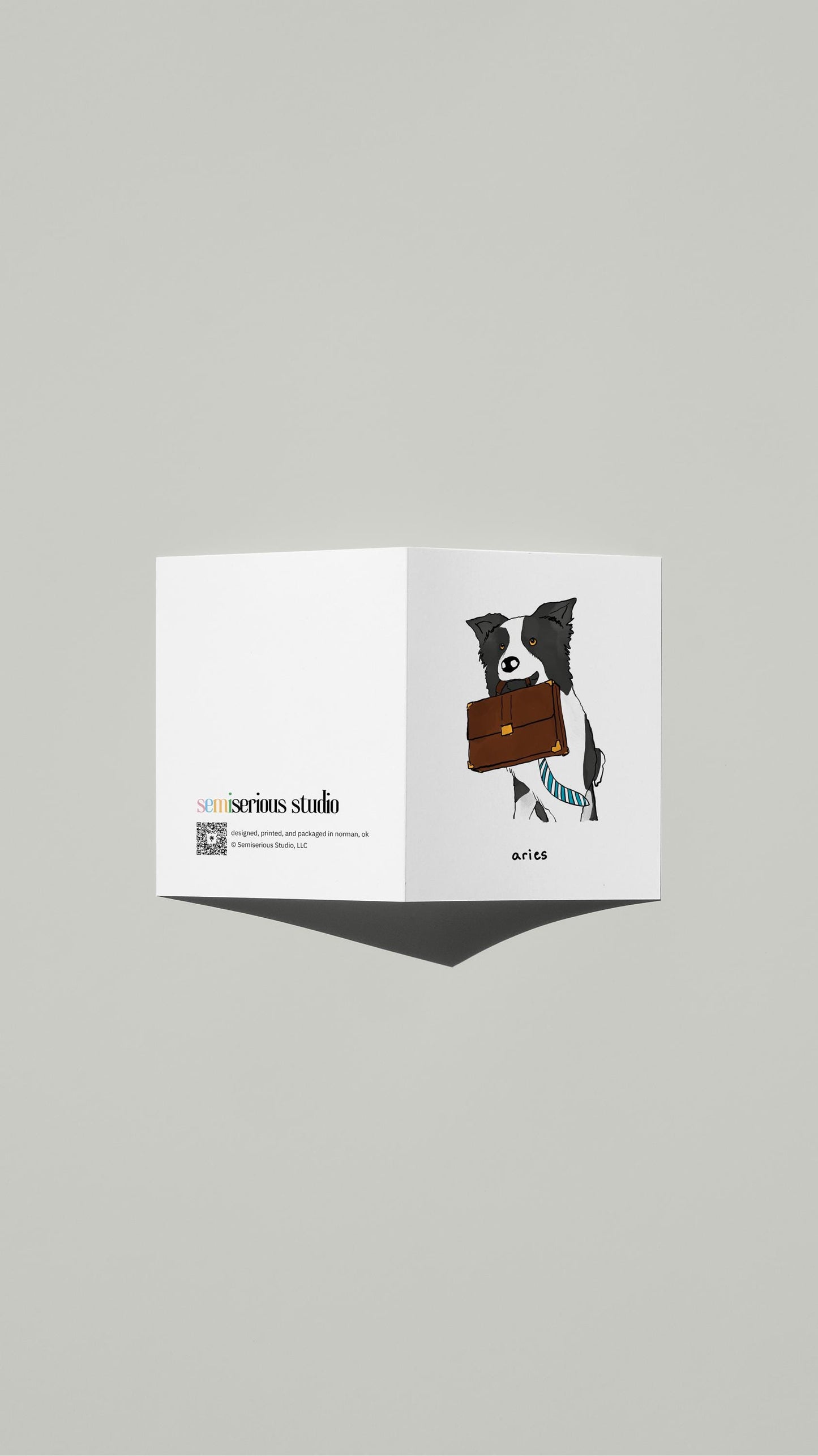 Aries Dog Birthday card standing open, showing the front artwork and the Semiserious Studio logo on the back