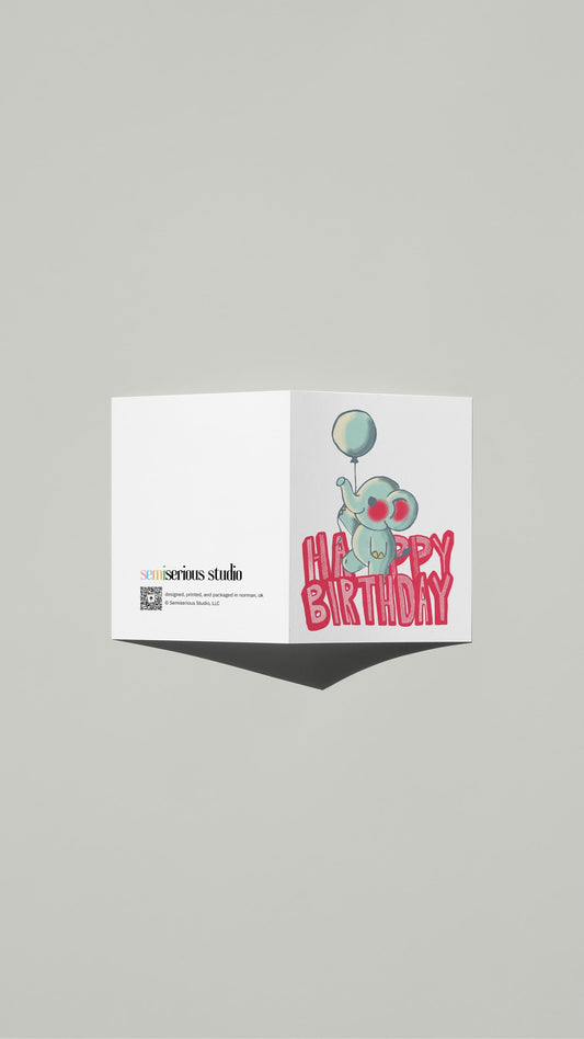 Baby Elephant Birthday card standing open, showing the front artwork and the Semiserious Studio logo on the back
