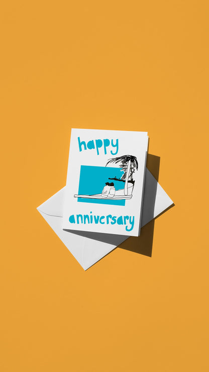 Hand-drawn illustration of two people sitting on a beach under a palm tree with the message "happy anniversary" in bright