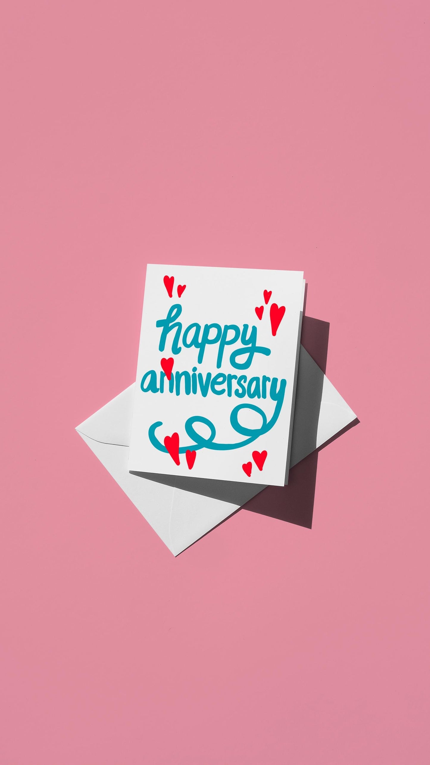 Hand-drawn illustration of red hearts with the message "happy anniversary" in blue