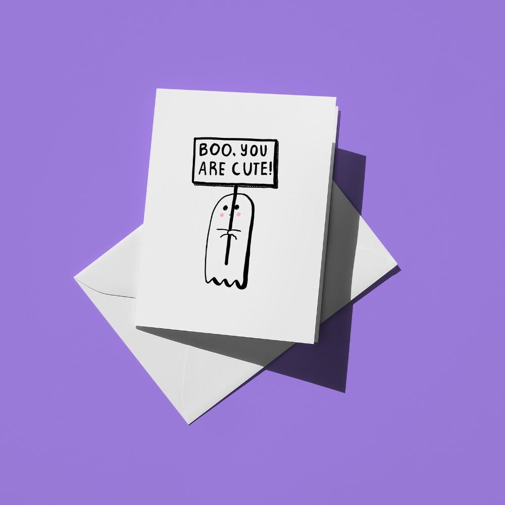 Hand-drawn illustration of a cute ghost holding a sign with the message "BOO, YOU ARE CUTE!"