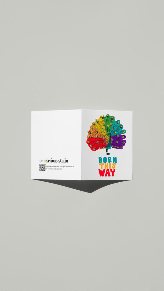 Born This Way Rainbow Peacock Pride card standing open, showing the front artwork and the Semiserious Studio logo on the back