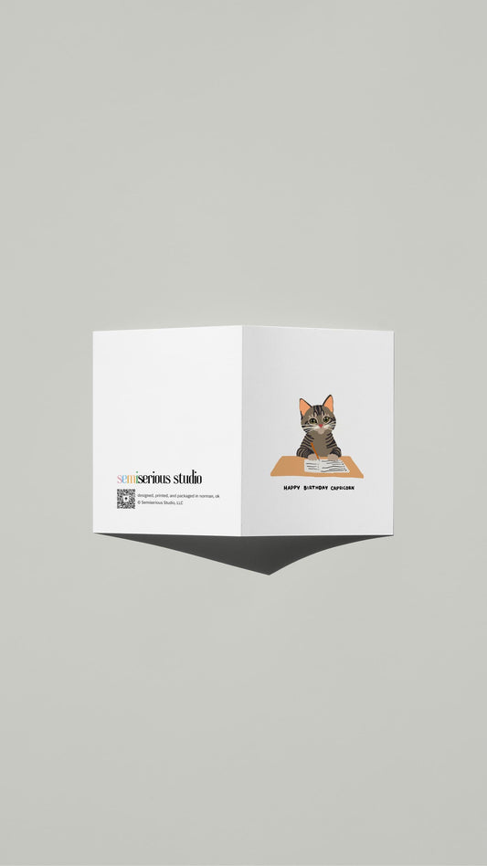 Capricorn Cat To-Do List Birthday card standing open, showing the front artwork and the Semiserious Studio logo on the back