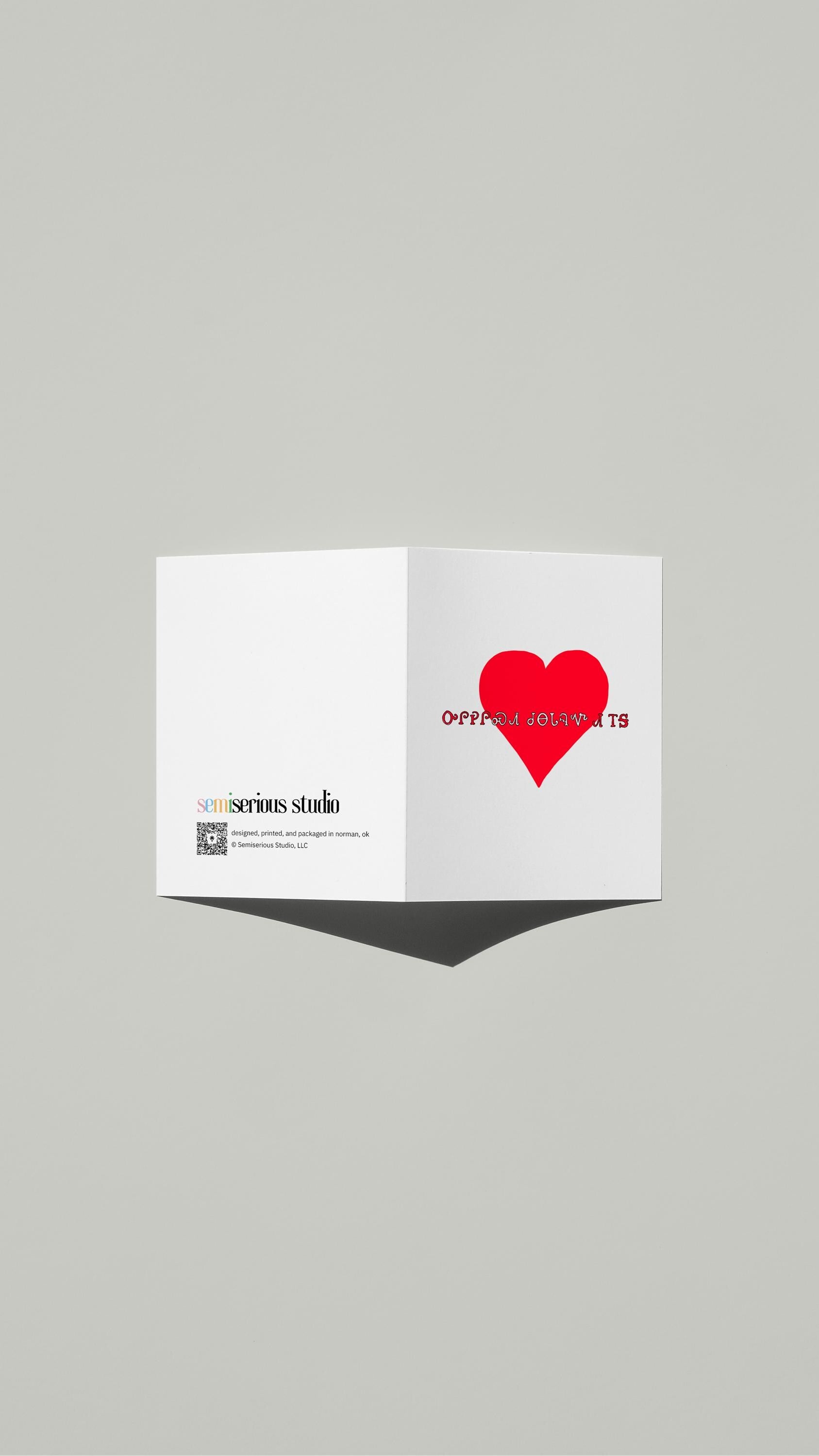 Cherokee Syllabary Valentine card standing open, showing the front artwork and the Semiserious Studio logo on the back