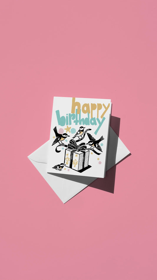 Hand-drawn illustration of four small birds unwrapping a birthday present with the message "happy birthday" in pastel colors