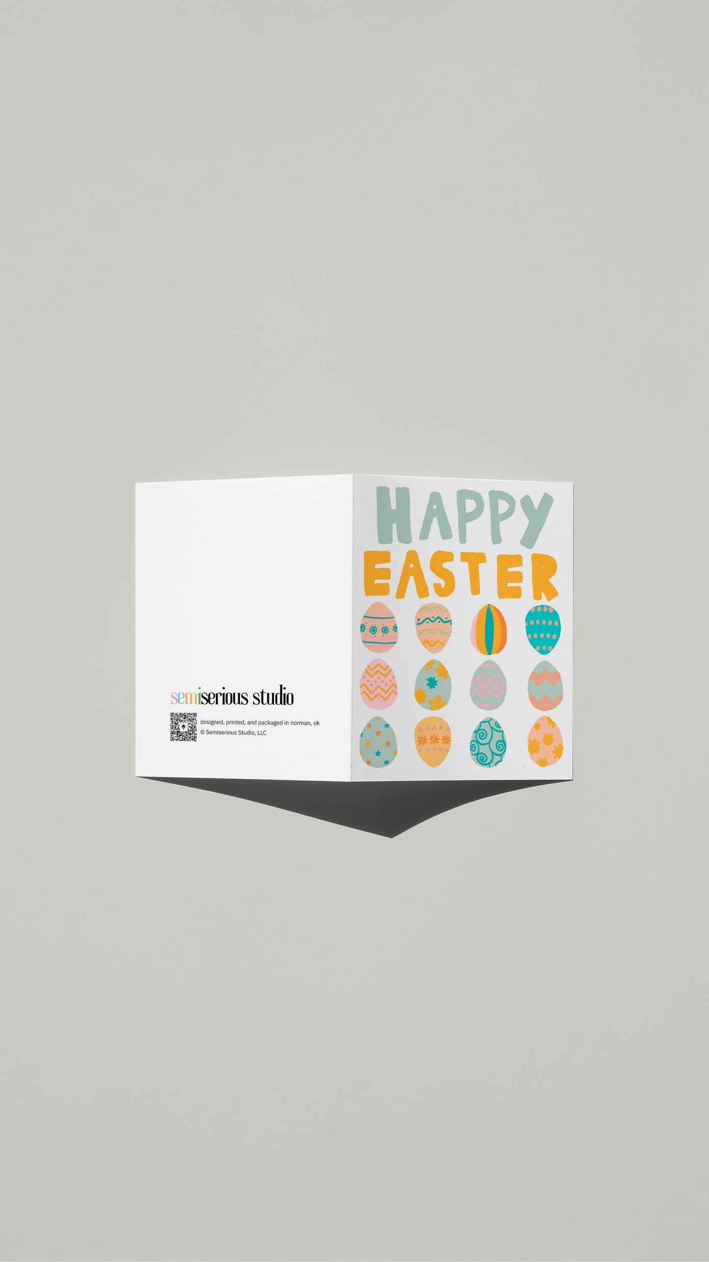 Colorful Easter Eggs card standing open, showing the front artwork and the Semiserious Studio logo on the back
