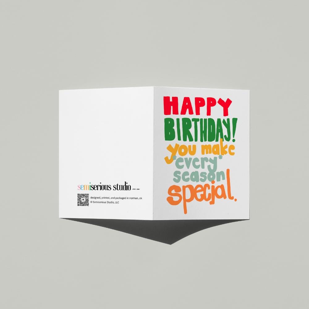 December Birthday Holiday card standing open, showing the front artwork and the Semiserious Studio logo on the back