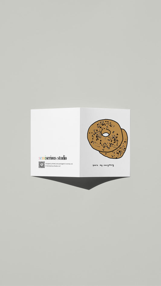Everything Bagel Valentine card standing open, showing the front artwork and the Semiserious Studio logo on the back