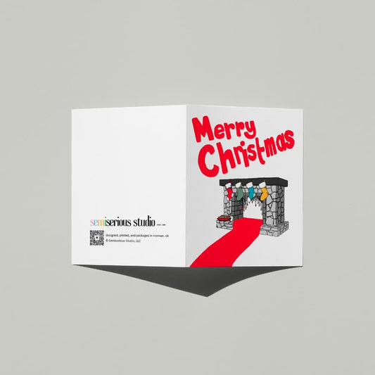 Fireplace Stockings Christmas card standing open, showing the front artwork and the Semiserious Studio logo on the back