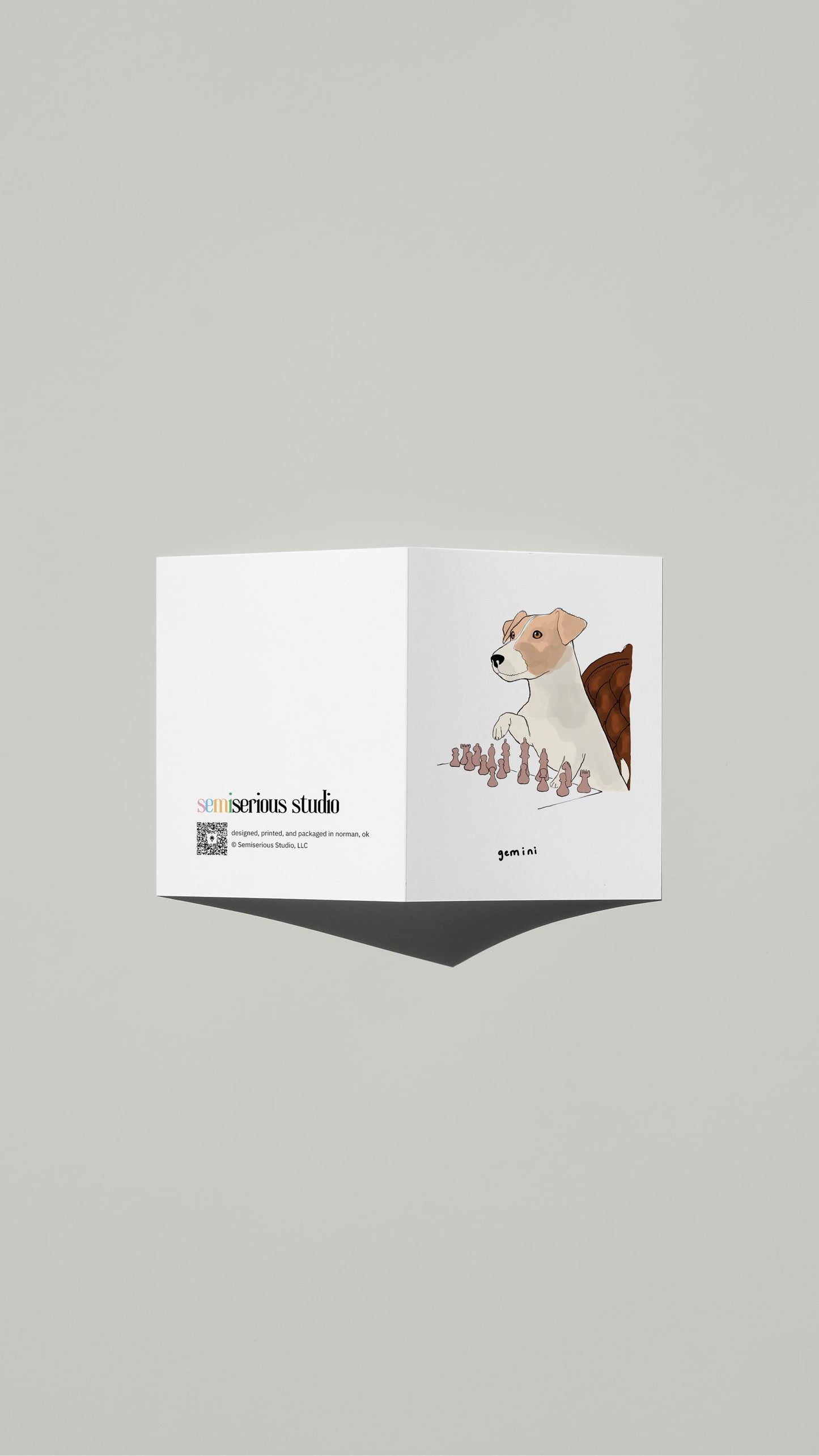 Gemini Jack Russell Chess Birthday card standing open, showing the front artwork and the Semiserious Studio logo on the back