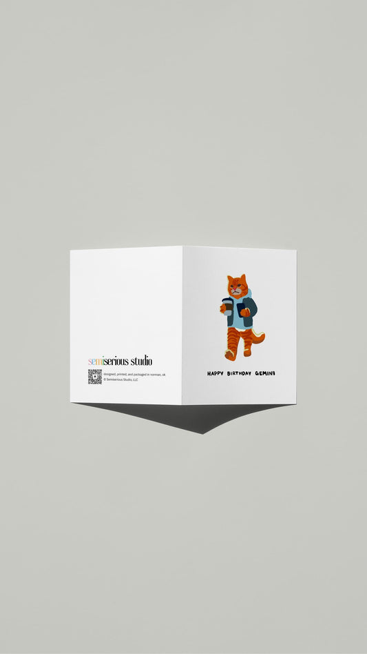 Gemini Tabby Cat Texting Birthday card standing open, showing the front artwork and the Semiserious Studio logo on the back