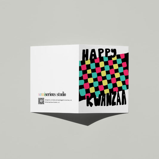 Happy Kwanzaa Mkeka card standing open, showing the front artwork and the Semiserious Studio logo on the back
