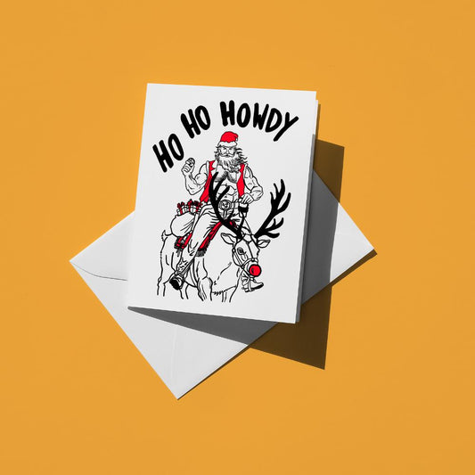 Black line drawing of a cowboy Santa riding a reindeer, reading "Ho ho howdy"