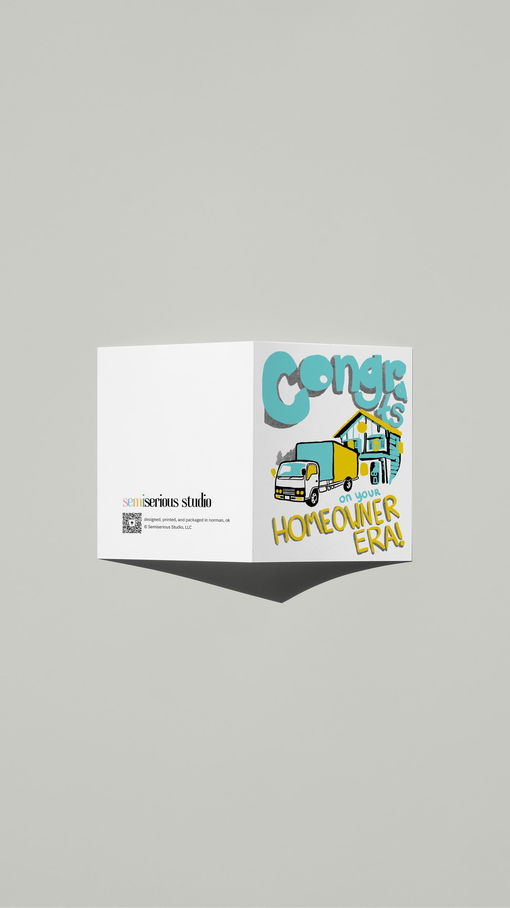 Homeowner Era Congratulations card standing open, showing the front artwork and the Semiserious Studio logo on the back