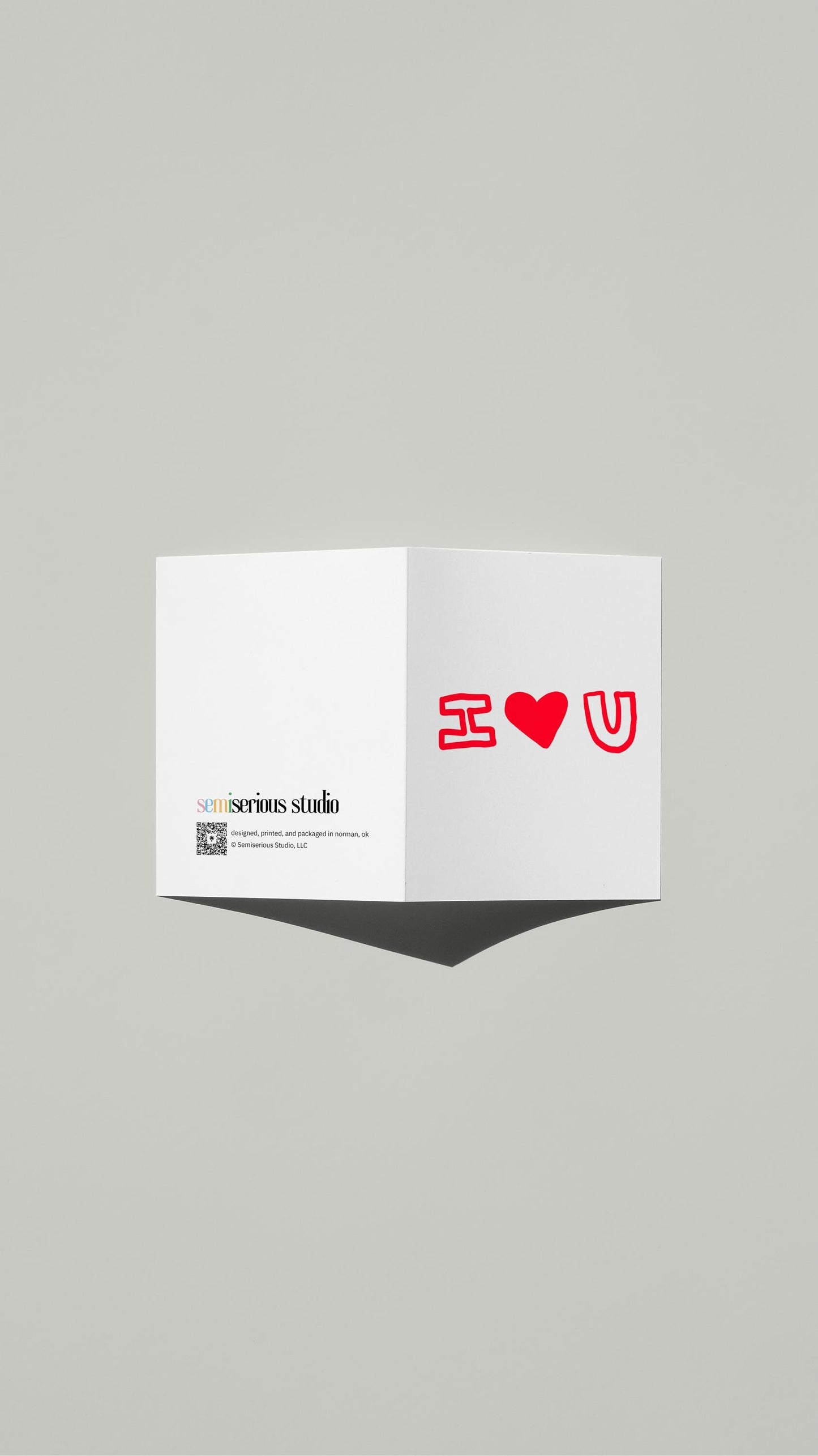 I Heart You Love card standing open, showing the front artwork and the Semiserious Studio logo on the back