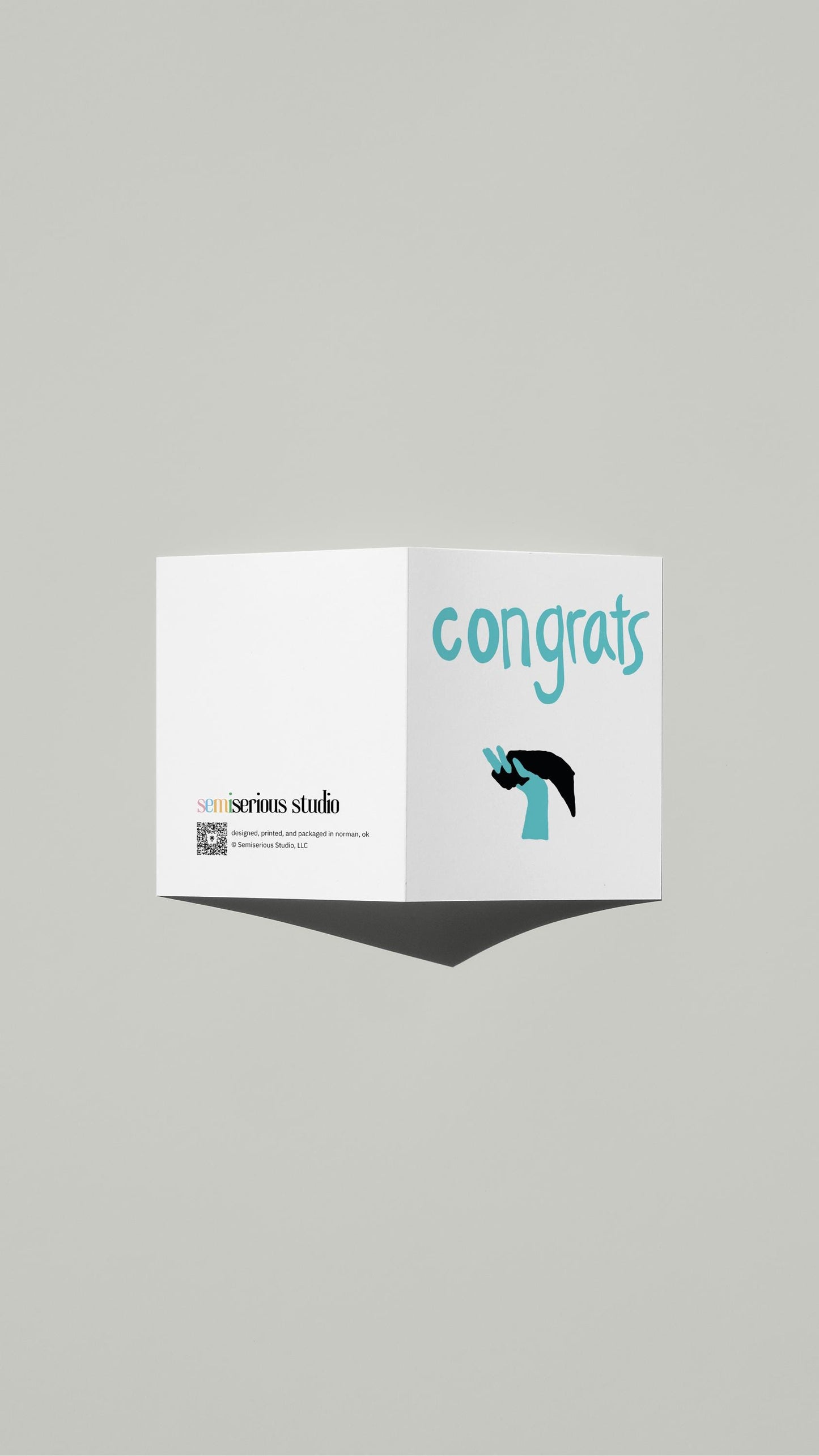 Interlocking Hands Wedding card standing open, showing the front artwork and the Semiserious Studio logo on the back