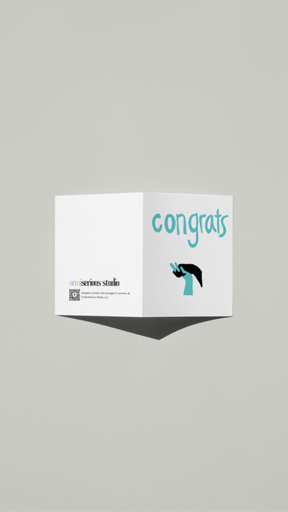 Interlocking Hands Wedding card standing open, showing the front artwork and the Semiserious Studio logo on the back