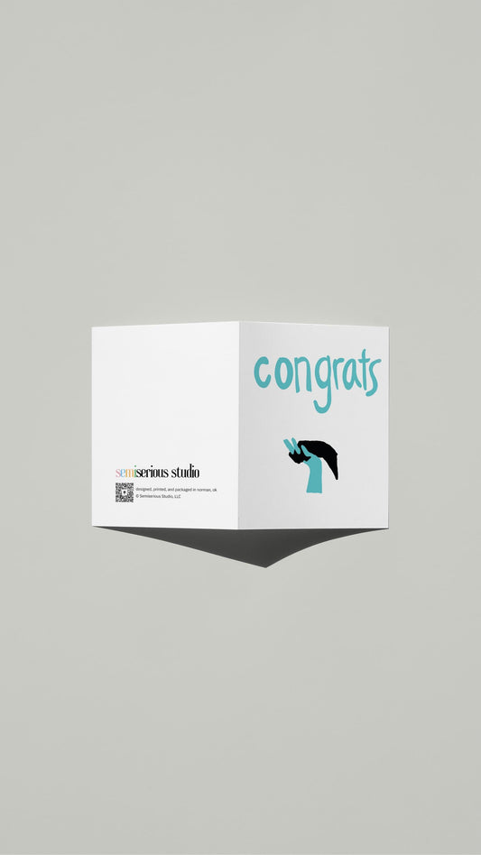 Interlocking Hands Wedding card standing open, showing the front artwork and the Semiserious Studio logo on the back
