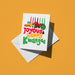 Kinara candles and a feast above multicolour text reading 