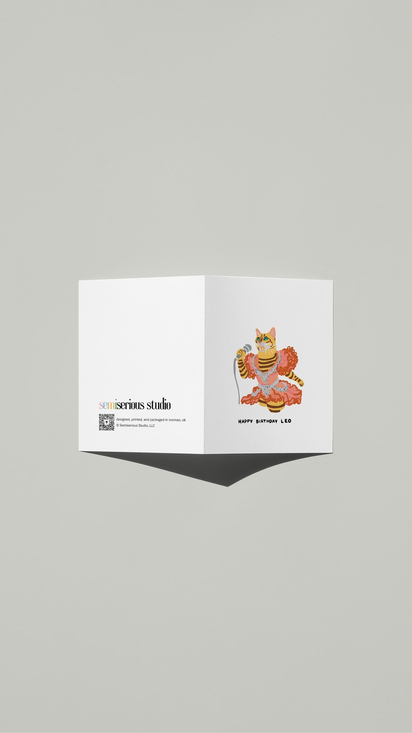 Leo Bengal Cat Karaoke Birthday card standing open, showing the front artwork and the Semiserious Studio logo on the back