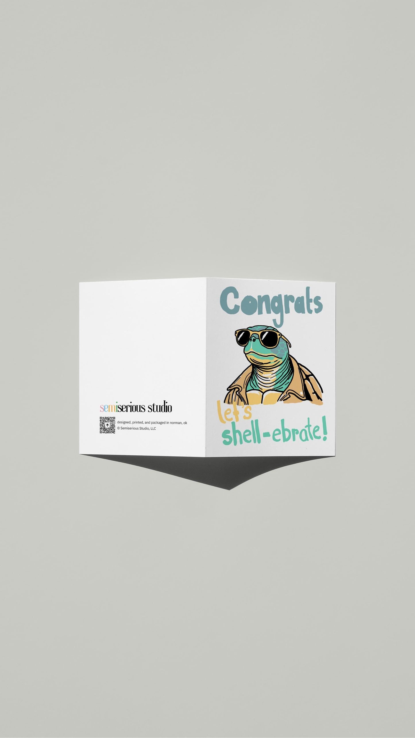 Let's Shell-ebrate Congratulations card standing open, showing the front artwork and the Semiserious Studio logo on the back
