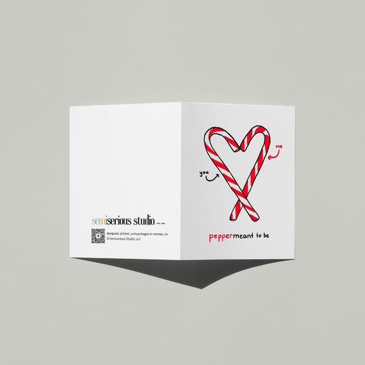 Meant to Be Punny Christmas card standing open, showing the front artwork and the Semiserious Studio logo on the back