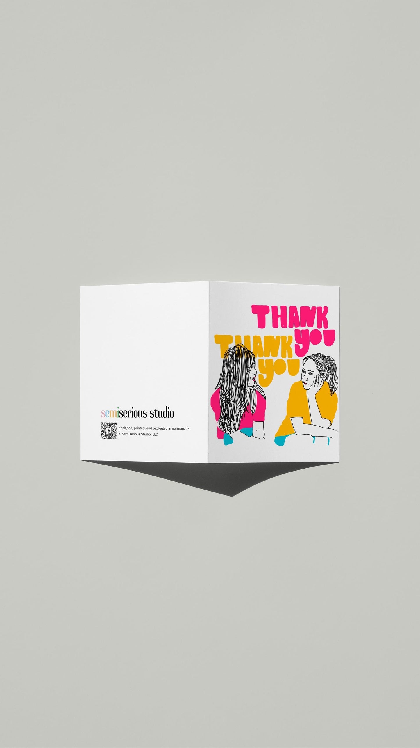 Neon Thank You card standing open, showing the front artwork and the Semiserious Studio logo on the back