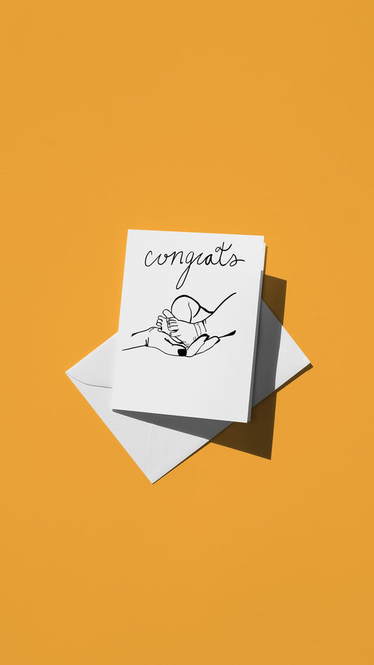 Hand-drawn illustration of a hand holding a newborn's foot with the message "congratulations"