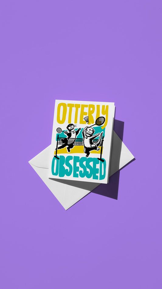 Hand-drawn illustration of two otters playing badminton with the message "OTTERLY OBSESSED"
