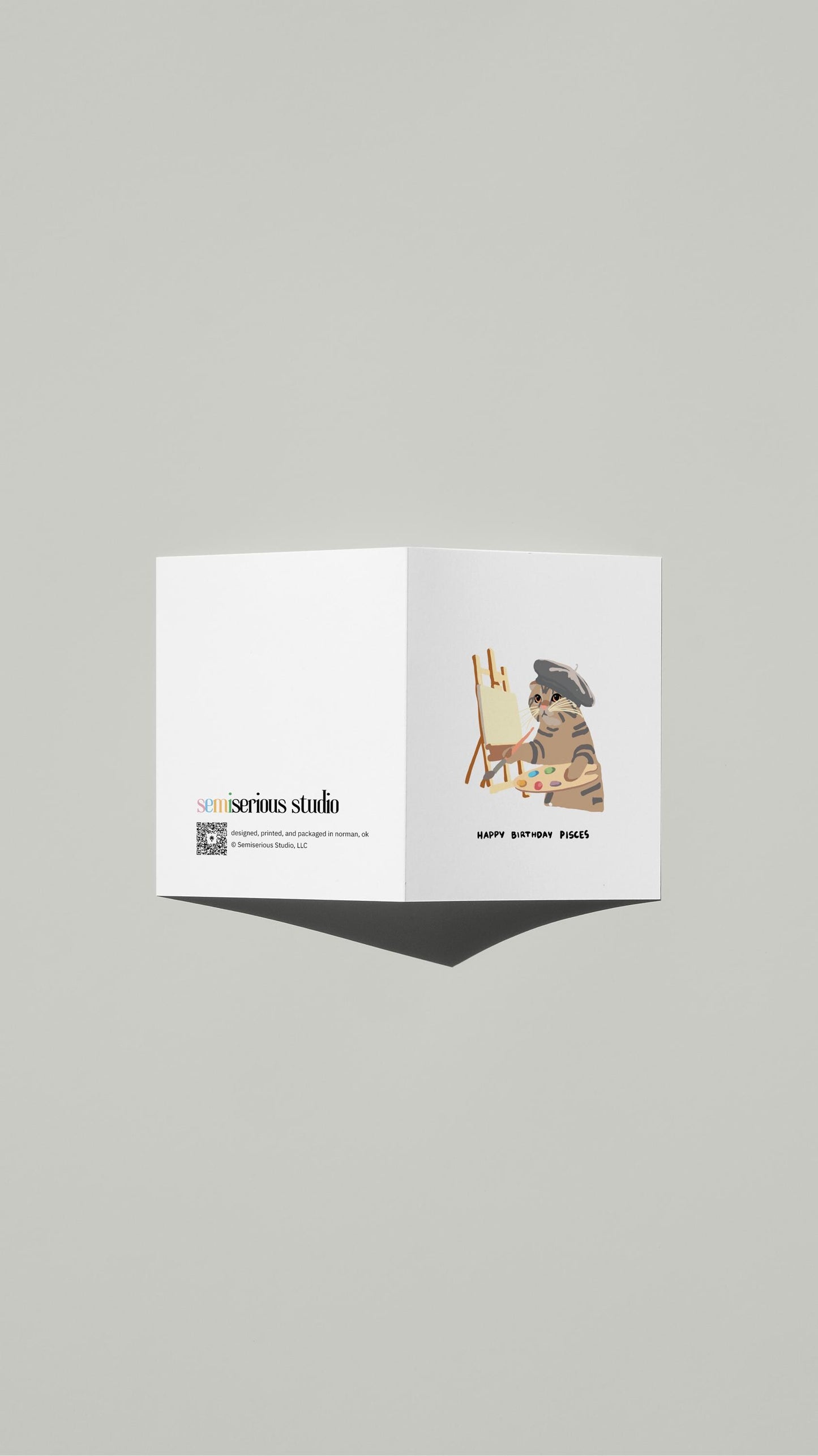 Pisces Ragdoll Cat Painting Birthday card standing open, showing the front artwork and the Semiserious Studio logo on the