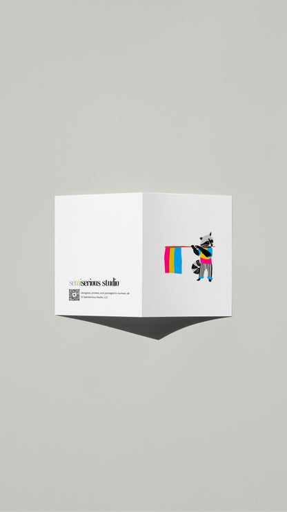 Raccoon Pansexual Pride card standing open, showing the front artwork and the Semiserious Studio logo on the back