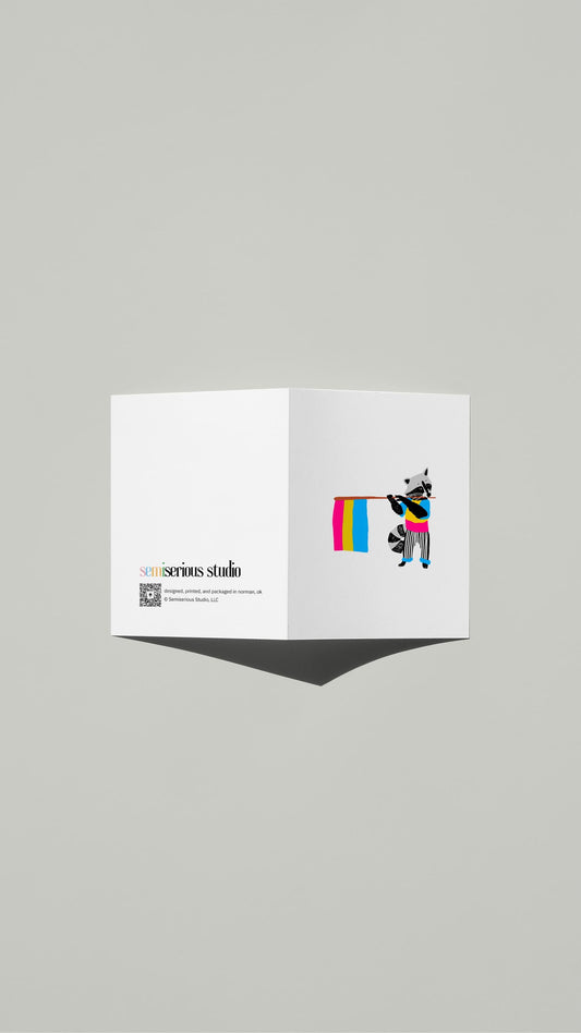 Raccoon Pansexual Pride card standing open, showing the front artwork and the Semiserious Studio logo on the back