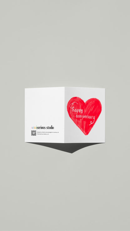 Red Heart Script Anniversary card standing open, showing the front artwork and the Semiserious Studio logo on the back
