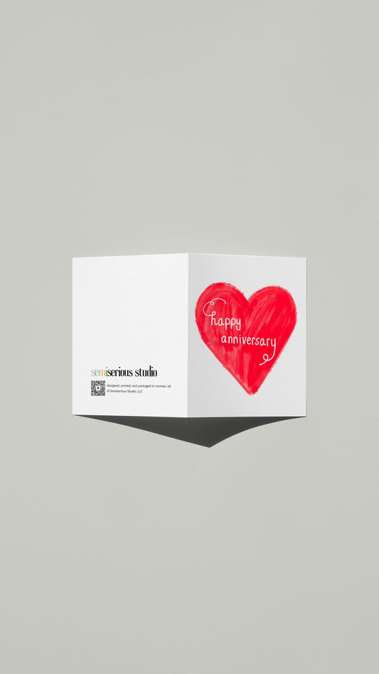 Red Heart Script Anniversary card standing open, showing the front artwork and the Semiserious Studio logo on the back