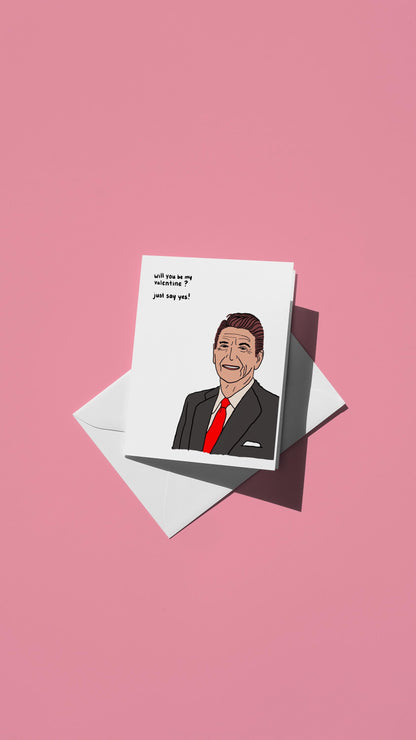 Hand-drawn illustration of Ronald Reagan with the message "will you be my valentine? just say yes!"