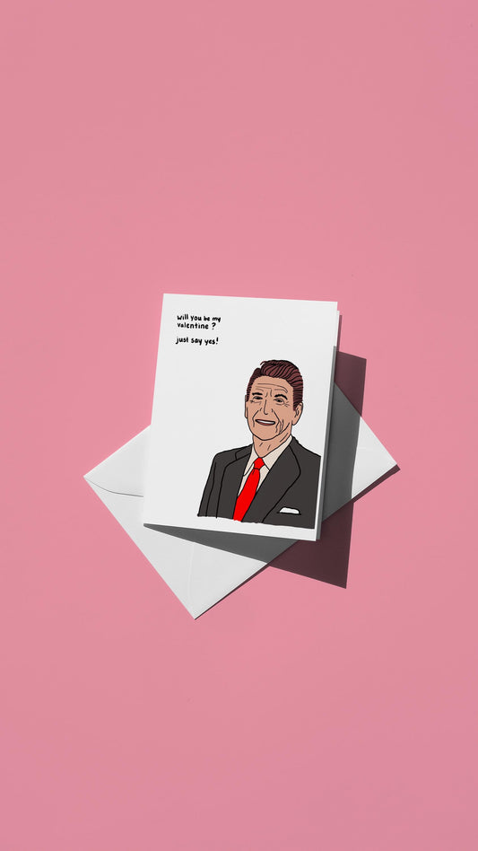 Hand-drawn illustration of Ronald Reagan with the message "will you be my valentine? just say yes!"