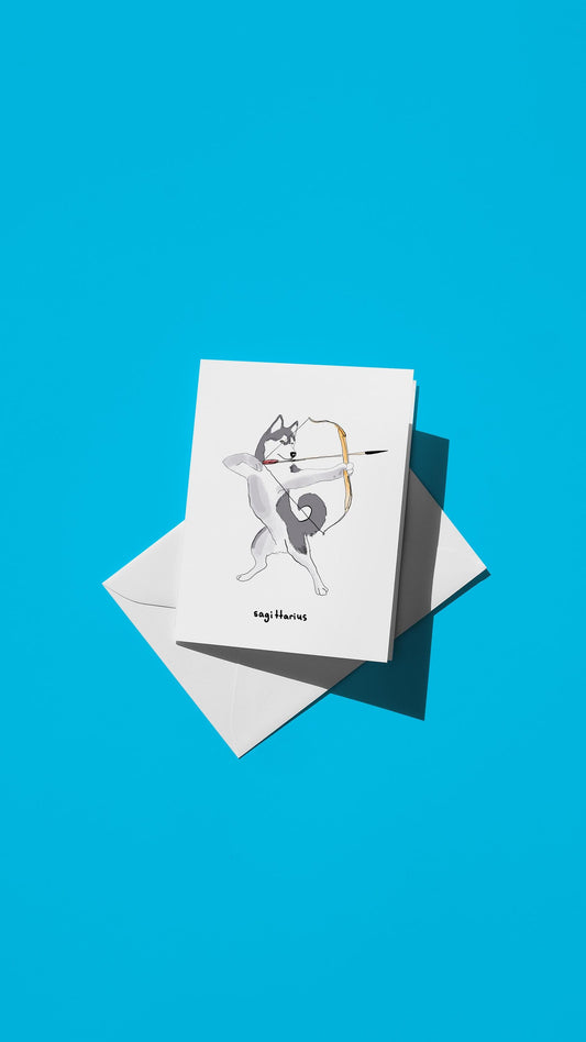 Hand-drawn illustration of a Husky with a bow and arrow with the message "sagittarius"