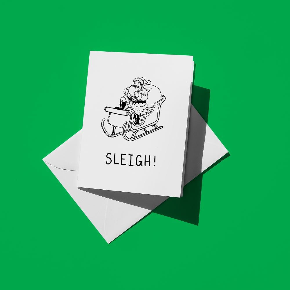 Black line drawing of Santa riding a sleigh, with text reading "Sleigh!"
