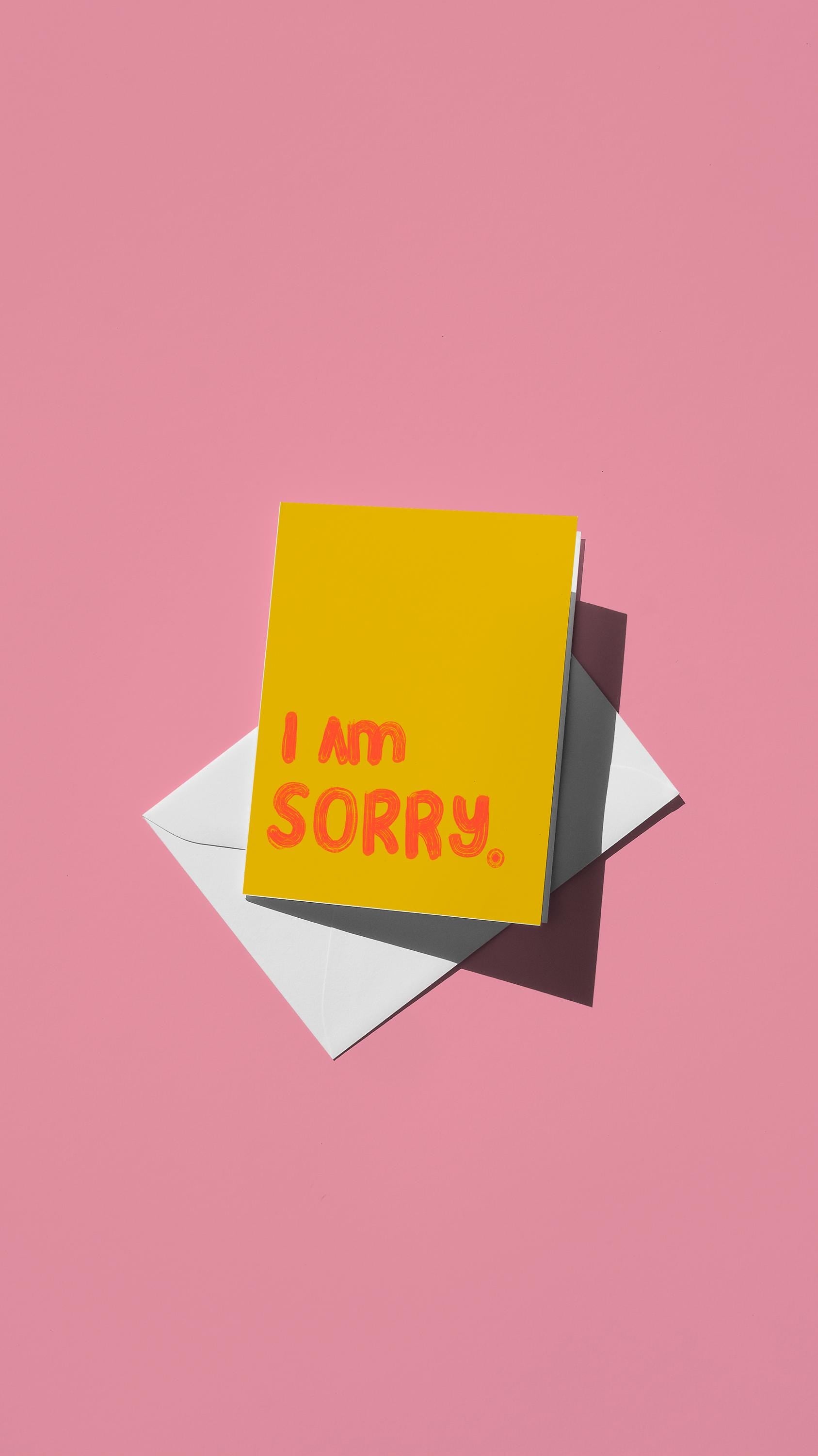 Hand-drawn illustration of "I AM SORRY." in red on a yellow background