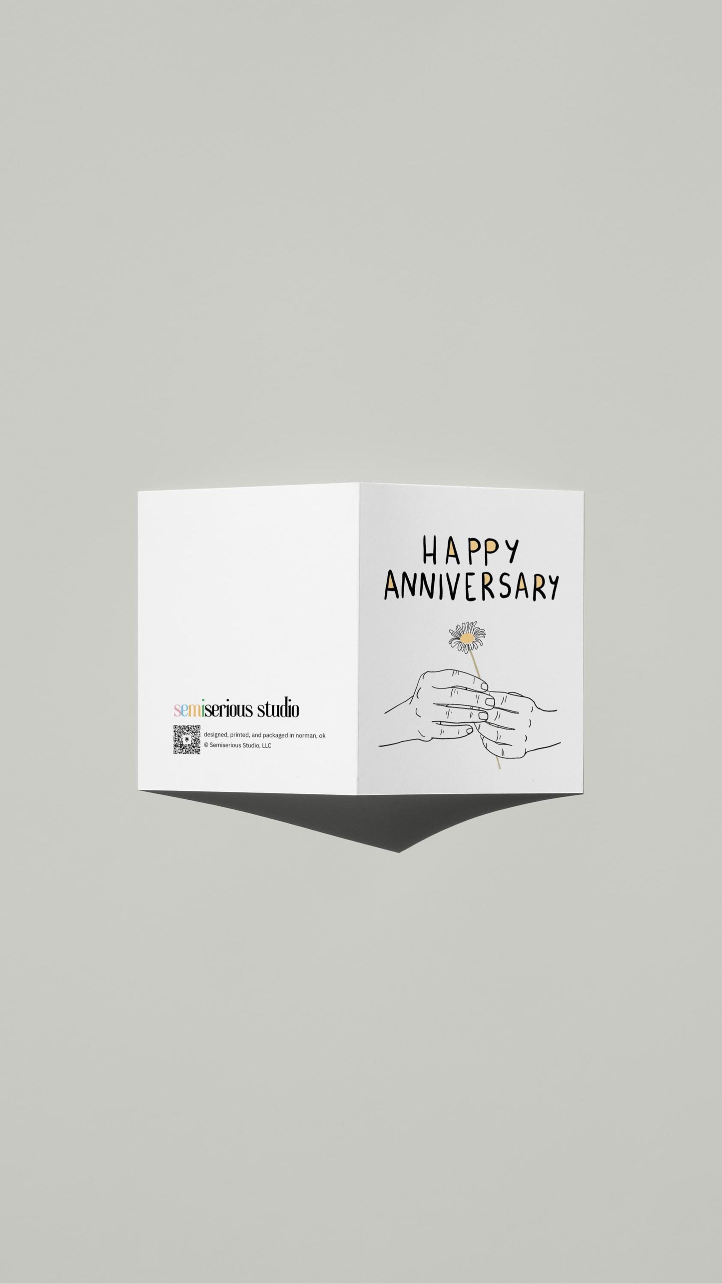 Single Flower Anniversary card standing open, showing the front artwork and the Semiserious Studio logo on the back
